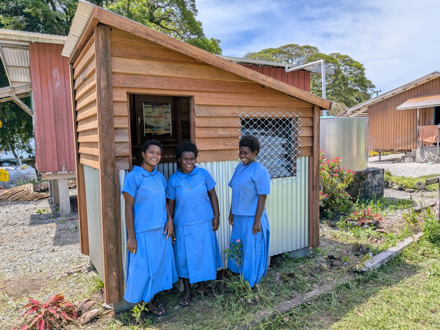Three women in front of the Powa Haus at Divit Rural Training Centre